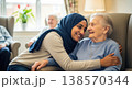 Female caregiver helping an older woman during daily care in a nursing facility. Calm indoor setting and attention. Concept of healthcare, assistance, and wellbeing. 138570344