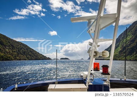 Boat crossing Fiordland fjord in New Zealand 138570524