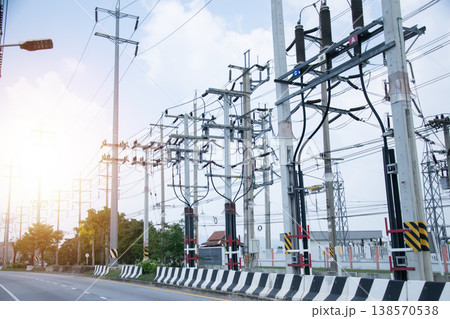 Electricity transmission towers line the side of the road. Electricity transmission towers line the side of the road. 138570538