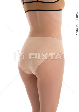 Rear view of a fit woman in seamless beige underwear isolated on a white background 138570552