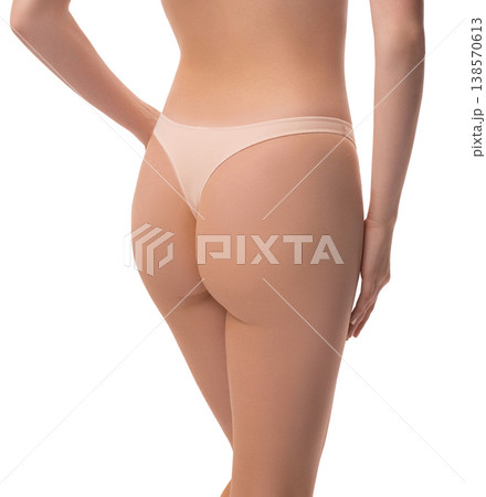 Woman's toned buttocks and slim waist in beige underwear. Rear view isolated on white Woman's toned buttocks and slim waist in beige underwear. Rear view isolated on white 138570613