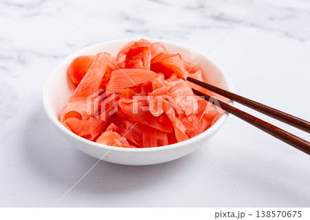 Pickled ginger, with chopsticks, in a small white bowl, on a marble countertop, close-up, no people, Pickled ginger, with chopsticks, in a small white bowl, on a marble countertop, close-up, no people, 138570675