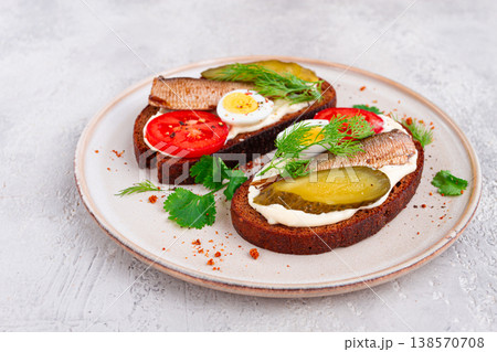 sandwiches on rye bread, with sprats, quail eggs, fresh tomatoes and pickled cucumber, appetizer, breakfast, homemade, 138570708