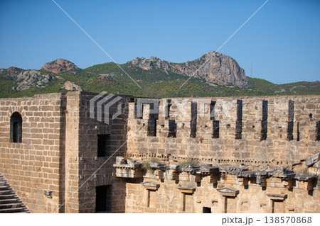 Part of the stone wall of the ancient amphitheater with architectural elements. Part of the stone wall of the ancient amphitheater with architectural elements. 138570868