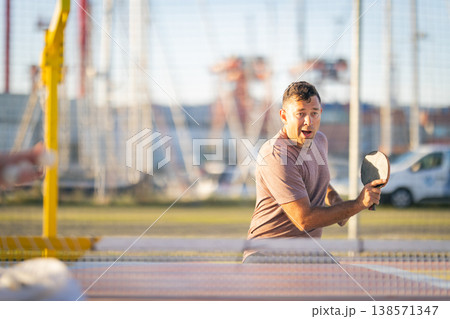 Man playing table tennis outdoors during leisure activity Man playing table tennis outdoors during leisure activity 138571347
