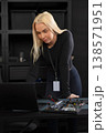 Female IT technician with laptop and hardware setup performing diagnostics and repair 138571951