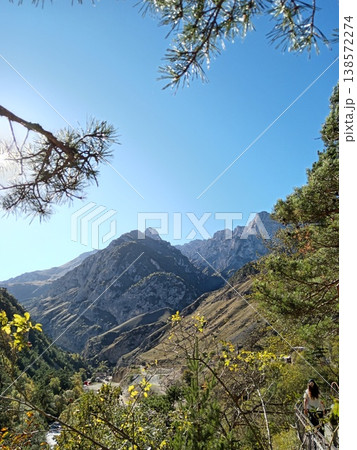 Caucasus Mountains landscape in North Ossetia, Russia, bright summer day. Natural beauty of the region with lush vegetation, steep gorges and clear mountain air Caucasus Mountains landscape in North Ossetia, Russia, bright summer day. Natural beauty of the region with lush vegetation, steep gorges and clear mountain air 138572274