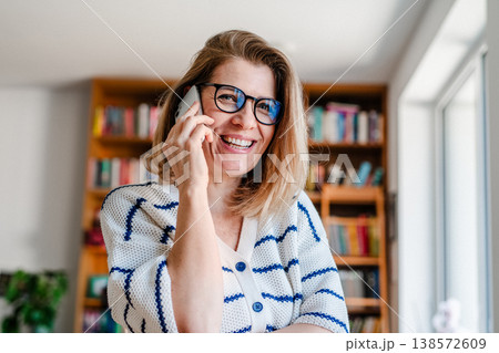 Woman making phone call at home. 138572609