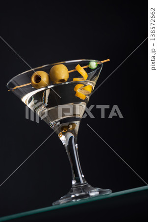Classic Martini with Olives and Lemon Twist on Dark Background. Elegant Cocktail Composition. 138572662