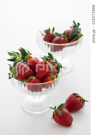 Summer Strawberries in Elegant Glass Bowls on White Table 138572666