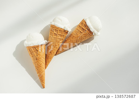 Vanilla Ice Cream Cones with Scoops on White Table Vanilla Ice Cream Cones with Scoops on White Table 138572687