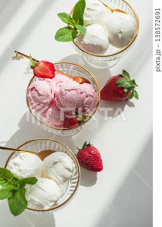 Vanilla and Strawberry Ice Cream in Elegant Bowls on White Background Vanilla and Strawberry Ice Cream in Elegant Bowls on White Background 138572691