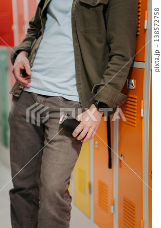 Teen student drinking an energy drink in school hallway. Teen student drinking an energy drink in school hallway. 138572758