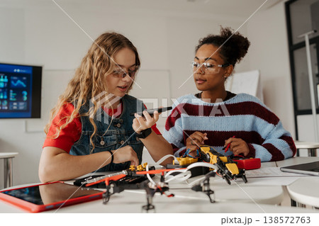 High school students working on robotics project. Girls in STEM. 138572763