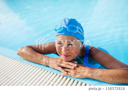 Elderly woman in swimming pool. Older female exercising for vitality and longevity. 138572818