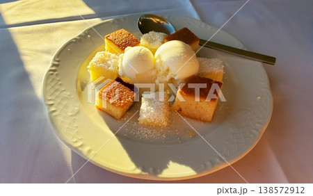 a few slices of plain cake and scoops of vanilla ice cream 138572912
