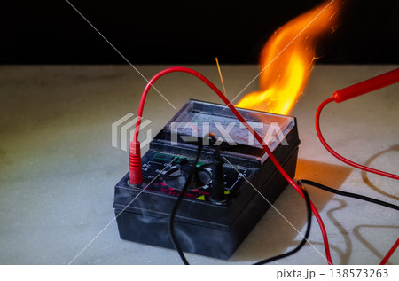 Burning multimeter with wires sparks flame smoke during electrical short circuit Burning multimeter with wires sparks flame smoke during electrical short circuit 138573263