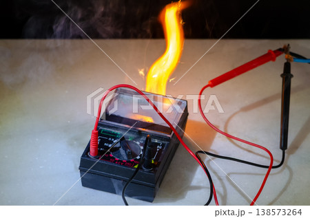 Multimeter fire with wires sparks flame and smoke during electrical short circuit Multimeter fire with wires sparks flame and smoke during electrical short circuit 138573264