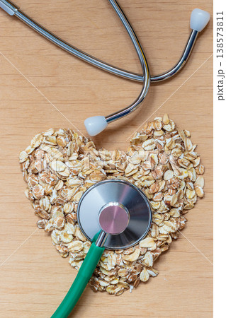 Oat flakes heart shaped and stethoscope. 138573811