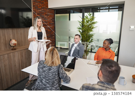 Woman Giving a Presentation to a Group of People Woman Giving a Presentation to a Group of People 138574184
