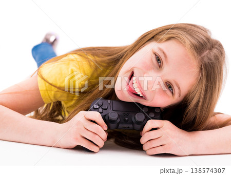 Cute long haired girl lying on the floor with a joystick, tired from playing games 138574307