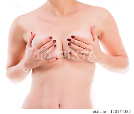 Naked girl holding her breast isolated on a white background Naked girl holding her breast isolated on a white background 138574380