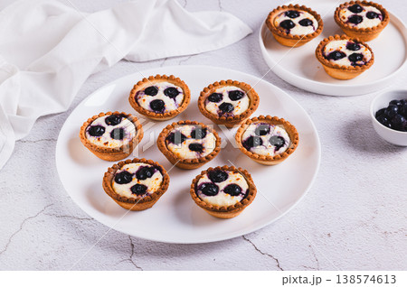 Mini cakes with cottage cheese and berries on a plate on the table 138574613