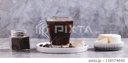 Black coffee with a piece of brie cheese in a glass on the table web banner Black coffee with a piece of brie cheese in a glass on the table web banner 138574640