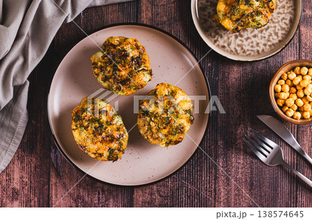 Potato halves baked with cheese, garlic and herbs on a plate on the table top view Potato halves baked with cheese, garlic and herbs on a plate on the table top view 138574645