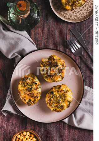 Baked potatoes with cheese and dill on a plate on the table top and vertical view 138574647