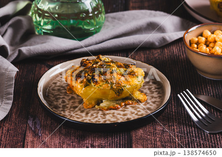 Crispy baked potatoes with cheese, garlic and dill on a plate 138574650