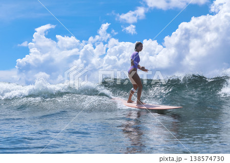 Young Woman On Surfboard Beside Coast Captures Seaside Lifestyle Young Woman On Surfboard Beside Coast Captures Seaside Lifestyle 138574730