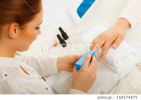 Woman getting manicure done file nails Woman getting manicure done file nails 138574875