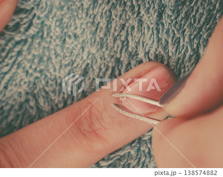 Beautician preparing nails before manicure, pushing back cuticles Beautician preparing nails before manicure, pushing back cuticles 138574882
