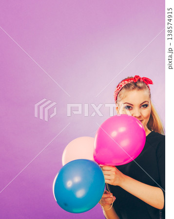 Lovely smiling girl holds colorful balloons. Lovely smiling girl holds colorful balloons. 138574915