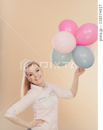 joyful girl playing with colorful balloons joyful girl playing with colorful balloons 138574917