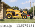 A Cat Telehandler parked in a driveway with blue sky A Cat Telehandler parked in a driveway with blue sky 138575181