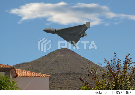 Military drone over residential area in Middle East region Military drone over residential area in Middle East region 138575367