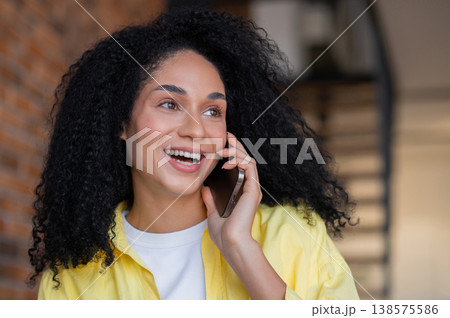 Pretty young long-haired woman in yellow jacket working from home Pretty young long-haired woman in yellow jacket working from home 138575586