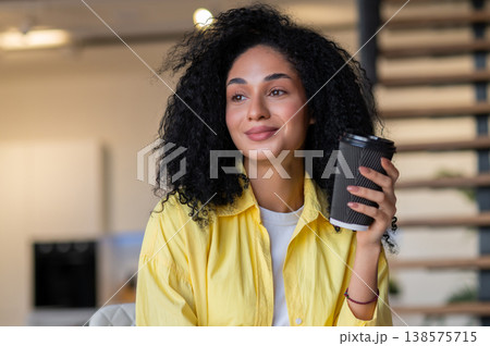 Pretty young brunette woman looking thoughtful Pretty young brunette woman looking thoughtful 138575715
