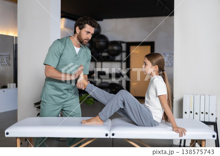 Close up of therapist hands massaging child foot Close up of therapist hands massaging child foot 138575743