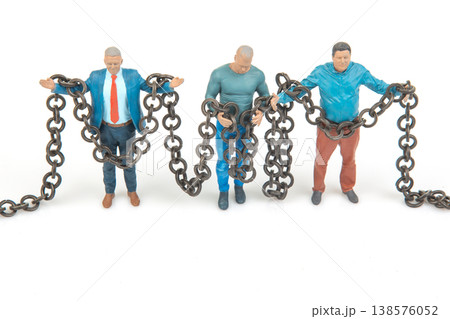 Miniature people holding chains in a creative...の写真素材 [138576052] - PIXTA