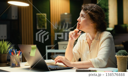 Genius businesswoman making a breakthrough discovery late at night, having a spark of the moment with a new innovative idea. Enlightenment and originality with a brilliant approach. Camera B. Genius businesswoman making a breakthrough discovery late at night, having a spark of the moment with a new innovative idea. Enlightenment and originality with a brilliant approach. Camera B. 138576888