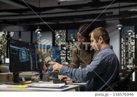 Diverse team of engineers using artificial intelligence to design a floor plan, working together with neural networks and computer aided apartment layout on architectural software. 138576946