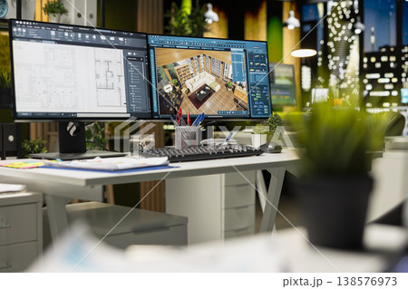 Professional interior design workspace showing modern computer monitors with architectural software used for drafting, layout and modeling. Creative environment optimized for productivity. 138576973