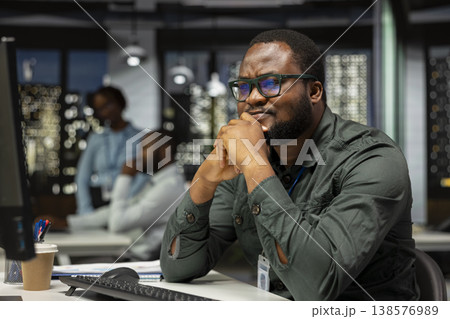 Business manager contemplating about new investment plan for success, envisioning new concept to develop the company activity. Tactical black guy planning objectives, searching for solutions. Business manager contemplating about new investment plan for success, envisioning new concept to develop the company activity. Tactical black guy planning objectives, searching for solutions. 138576989