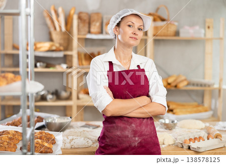 Woman baker standing with folded arms Woman baker standing with folded arms 138578125