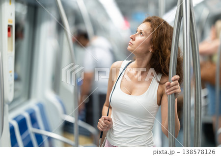 Portrait of woman passenger standing inside train at metro wagon 138578126