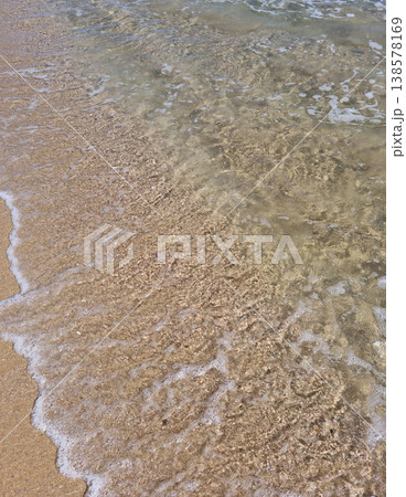 It is a sandy beach with waves rolling in. 138578169