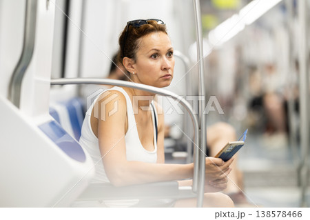 Portrait of pretty woman commuting in city using subway train Portrait of pretty woman commuting in city using subway train 138578466